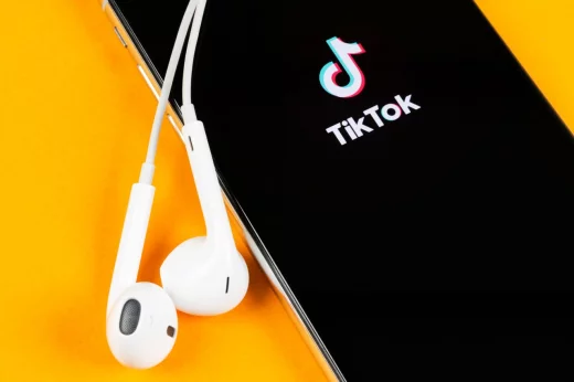 Tik Tok application icon on Apple iPhone X screen close-up