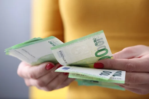 Woman is counting one hundred euro bills. Payroll concept