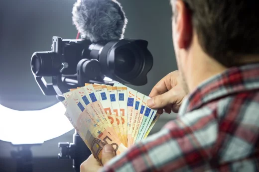 Man holds euros in front of camera