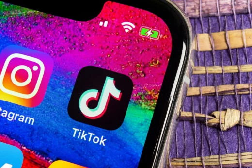 Tik Tok application icon on Apple iPhone X screen close-up