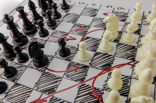 A white board with chess pieces on it, the battle plan