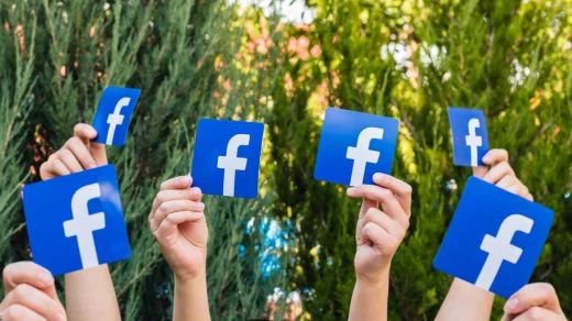 Many people. Female. Teenager. Man. Hold the logo of a popular social network Facebook