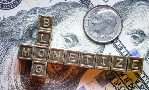 monetize blog phrase made from metallic letter blocks over dollar banknotes