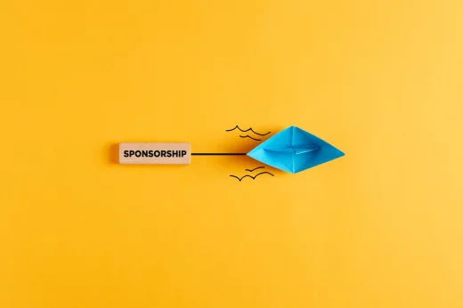 Paper boat pulls a wooden banner with the word sponsorship