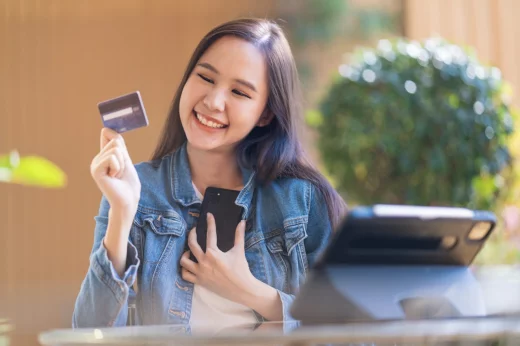 Lucky girl with a credit card and a smartphone